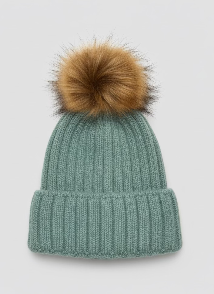 Green knit beanie with a large brown fur pom-pom on a white background