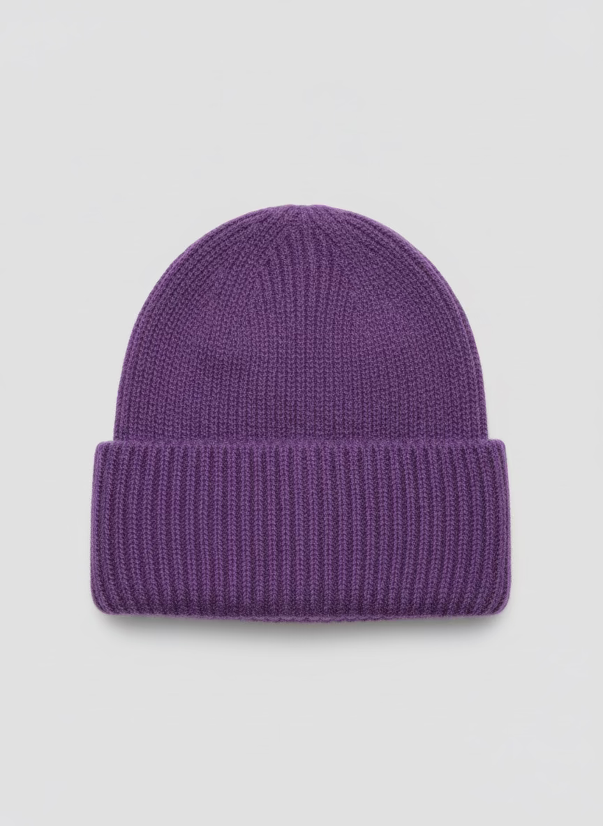 Purple knit beanie on a white surface